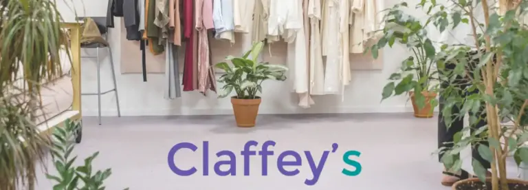 A boutique shop interior with potted plants on the floor, clothing hanging on rails in the background, and the word "Claffey’s" in large text across the bottom.