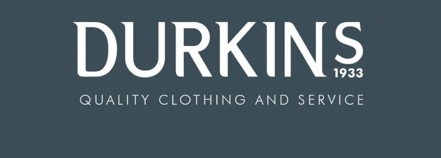 The image features the text "DURKINS 1933" in bold white letters, with "QUALITY CLOTHING AND SERVICE" written below in smaller white font on a dark grey background.